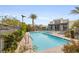 Refreshing community pool and jacuzzi, complete with lounge chairs, lush landscaping, and nearby modern residential buildings at 11283 Gravitation Dr, Las Vegas, NV 89135