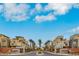 Inviting street view into the Affinity community, showcasing modern homes and lush palm tree-lined boulevard at 11283 Gravitation Dr, Las Vegas, NV 89135