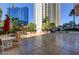 Expansive courtyard featuring tables and chairs, shaded by umbrellas, and lush landscaping at 125 E Harmon Ave # 1620, Las Vegas, NV 89109