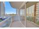 Open balcony with city views, showcasing a palm tree, and a glimpse of the Las Vegas skyline at 135 E Harmon Ave # 221, Las Vegas, NV 89109