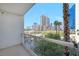Balcony with a view of resort-style pool, palm trees, and surrounding Las Vegas buildings at 135 E Harmon Ave # 221, Las Vegas, NV 89109