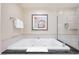 Luxurious bathroom featuring deep soaking tub and glass enclosed shower with modern fixtures at 135 E Harmon Ave # 221, Las Vegas, NV 89109