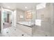 Bright bathroom with large tub, glass shower, and access to the bedroom at 135 E Harmon Ave # 221, Las Vegas, NV 89109