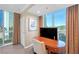 Corner bedroom with a wooden desk, large windows offering cityscape views at 135 E Harmon Ave # 221, Las Vegas, NV 89109