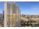 Exterior view of a high-rise condo building with gold tinted windows and Las Vegas cityscape views at 135 E Harmon Ave # 221, Las Vegas, NV 89109