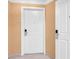 Hallway featuring white doors with digital locks and neutral colored walls at 135 E Harmon Ave # 221, Las Vegas, NV 89109