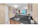 Modern kitchenette featuring black granite countertop and stainless steel sink, perfect for in-room convenience at 135 E Harmon Ave # 221, Las Vegas, NV 89109