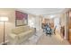 Comfortable living room with a couch, chairs, and view into the kitchen area with barstool seating at 135 E Harmon Ave # 221, Las Vegas, NV 89109