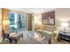 Comfortable living room features a plush sofa, glass table and balcony with city views at 135 E Harmon Ave # 221, Las Vegas, NV 89109