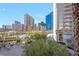 View from the condo overlooking a resort-style pool with lounge chairs, tables, and surrounding buildings at 135 E Harmon Ave # 221, Las Vegas, NV 89109
