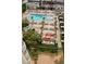 Aerial view of a pool area featuring palm trees, lounge chairs, cabanas, and well-maintained landscaping at 135 E Harmon Ave # 221, Las Vegas, NV 89109