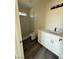 A modern bathroom features a single sink vanity with white cabinets and stone countertops at 1351 Huckleberry St, Pahrump, NV 89048