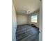 Bedroom featuring gray wood-look flooring, ceiling fan, and natural light at 1351 Huckleberry St, Pahrump, NV 89048