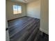 This bedroom features hardwood floors and a window with a beautiful view at 1351 Huckleberry St, Pahrump, NV 89048