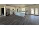Modern kitchen with white cabinetry, stainless steel appliances, marble countertops and hardwood floors at 1351 Huckleberry St, Pahrump, NV 89048