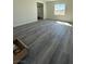 Bright living room featuring gray wood-look flooring and lots of natural light at 1351 Huckleberry St, Pahrump, NV 89048
