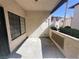 Spacious, covered balcony with textured walls, security door, and privacy partition at 1403 Santa Margarita St # D, Las Vegas, NV 89146