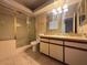 Bathroom with vanity, shower, and tub with sliding glass doors at 1403 Santa Margarita St # D, Las Vegas, NV 89146