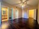 Bedroom with hardwood floors, ceiling fan, bright windows, and access to bathroom and closet at 1403 Santa Margarita St # D, Las Vegas, NV 89146