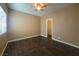 Bedroom with hardwood floors, ceiling fan, bright window, and walk-in closet at 1403 Santa Margarita St # D, Las Vegas, NV 89146