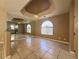 Bright dining room area featuring tile floors, a mirrored wall, and tray ceiling detail at 1403 Santa Margarita St # D, Las Vegas, NV 89146