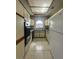 Galley-style kitchen with tile flooring, light cabinets, and white appliances at 1403 Santa Margarita St # D, Las Vegas, NV 89146