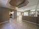 Spacious living room with tile flooring, and a peek into the kitchen area and view of the entryway at 1403 Santa Margarita St # D, Las Vegas, NV 89146
