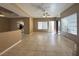 Open-concept living room featuring tile floors, ceiling fan, and a partial view of the kitchen at 1403 Santa Margarita St # D, Las Vegas, NV 89146