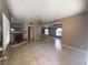 Open-concept living room with tile flooring, ceiling fan, and mirrored fireplace accent at 1403 Santa Margarita St # D, Las Vegas, NV 89146
