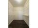 Walk-in closet with hardwood floors and wire shelving for storage at 1403 Santa Margarita St # D, Las Vegas, NV 89146
