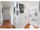 Hallway view with white walls, wood floors, and access to the bathroom at 147 Cervantes St, Las Vegas, NV 89101