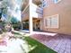 A large backyard with a covered patio and mature landscaping offers great potential for relaxation and entertainment at 150 Short Ruff Way, Las Vegas, NV 89148