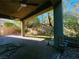Covered patio with ceiling fans overlooking the beautiful backyard with brick pavers, a lawn, and mature trees at 150 Short Ruff Way, Las Vegas, NV 89148