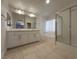 Modern bathroom with double sink vanity, soaking tub, and glass-enclosed shower at 150 Short Ruff Way, Las Vegas, NV 89148