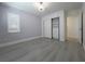 Bedroom with a gray accent wall, closet with sliding doors, base trim, and a light-colored wood-look floor at 150 Short Ruff Way, Las Vegas, NV 89148