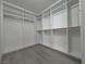 Walk-in closet with new floors, and built-in shelving and hanging rods for organization at 150 Short Ruff Way, Las Vegas, NV 89148