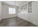 Bright dining room features custom built-ins with glass doors and modern light fixture at 150 Short Ruff Way, Las Vegas, NV 89148
