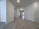 Hallway with gray wood flooring and white trim that provides access to different rooms at 150 Short Ruff Way, Las Vegas, NV 89148