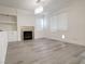 Cozy living room featuring hardwood floors, fireplace and a modern chandelier with lots of natural light at 150 Short Ruff Way, Las Vegas, NV 89148
