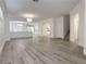 Bright, open-concept living room with hardwood floors, a modern chandelier, and an archway at 150 Short Ruff Way, Las Vegas, NV 89148