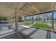 Wonderful back yard with artificial turf, covered patio, and view of green space at 1598 Bermuda Dunes Dr, Boulder City, NV 89005