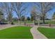 Manicured backyard with artificial turf, desert landscaping, and golf course views at 1598 Bermuda Dunes Dr, Boulder City, NV 89005