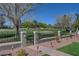 Well-maintained backyard with artificial turf, desert landscaping, and access to a golf course at 1598 Bermuda Dunes Dr, Boulder City, NV 89005