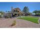 Backyard features desert landscaping with a charming patio and well-maintained artificial turf at 1598 Bermuda Dunes Dr, Boulder City, NV 89005