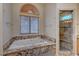 Primary bathroom with bathtub and shower, granite countertops and wood look floors at 1598 Bermuda Dunes Dr, Boulder City, NV 89005