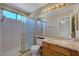 Neutral bathroom with granite counters, tile floor, and shower with sliding glass door at 1598 Bermuda Dunes Dr, Boulder City, NV 89005