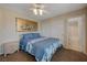 Cozy bedroom featuring large art, closet and access to ensuite bathroom at 1598 Bermuda Dunes Dr, Boulder City, NV 89005