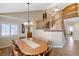 Inviting dining area featuring a long table, chandelier, and access to a staircase at 1598 Bermuda Dunes Dr, Boulder City, NV 89005