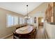 Comfortable dining area with large windows and a classic chandelier at 1598 Bermuda Dunes Dr, Boulder City, NV 89005