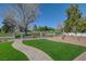 The grassy front yard has a brick walkway and an iron fence at 1598 Bermuda Dunes Dr, Boulder City, NV 89005